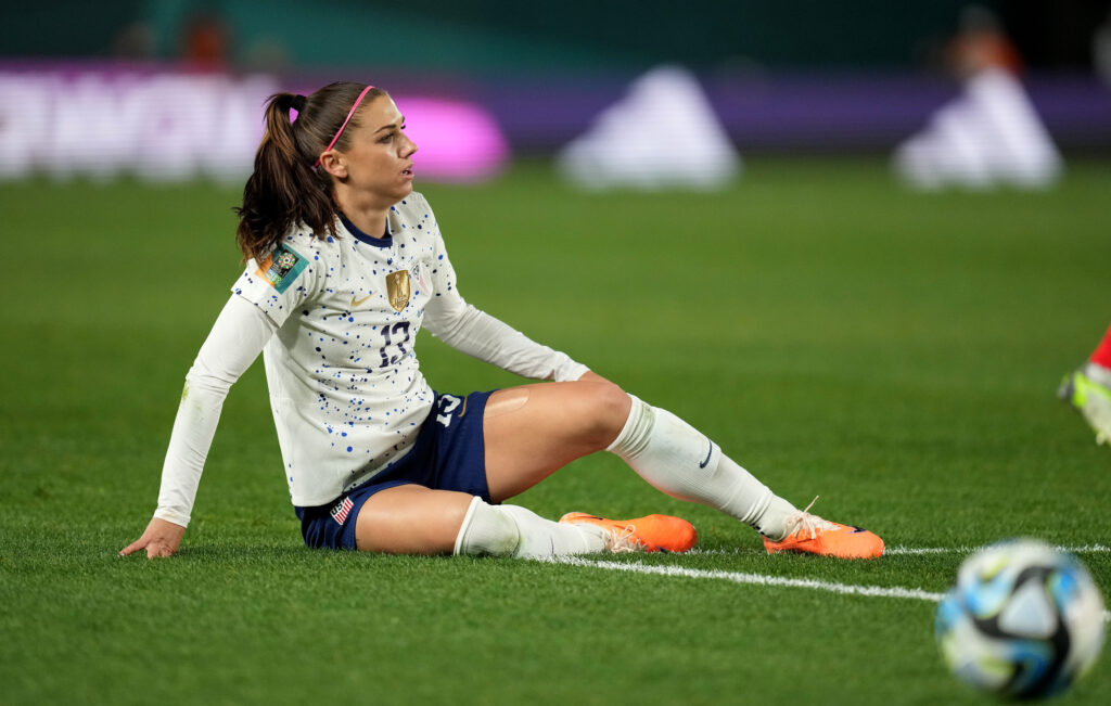 USWNT veteran Alex Morgan is pictured on the ground during match play