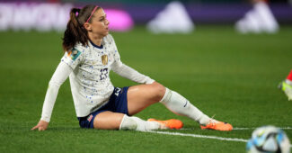 USWNT veteran Alex Morgan is pictured on the ground during match play