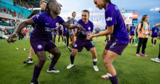 Orlando Pride players celebrate by dancing together after a win over the Kansas City Current
