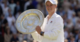 Barbora Krejcikova holds the winner's trophy after claiming the 2024 Wimbledon title