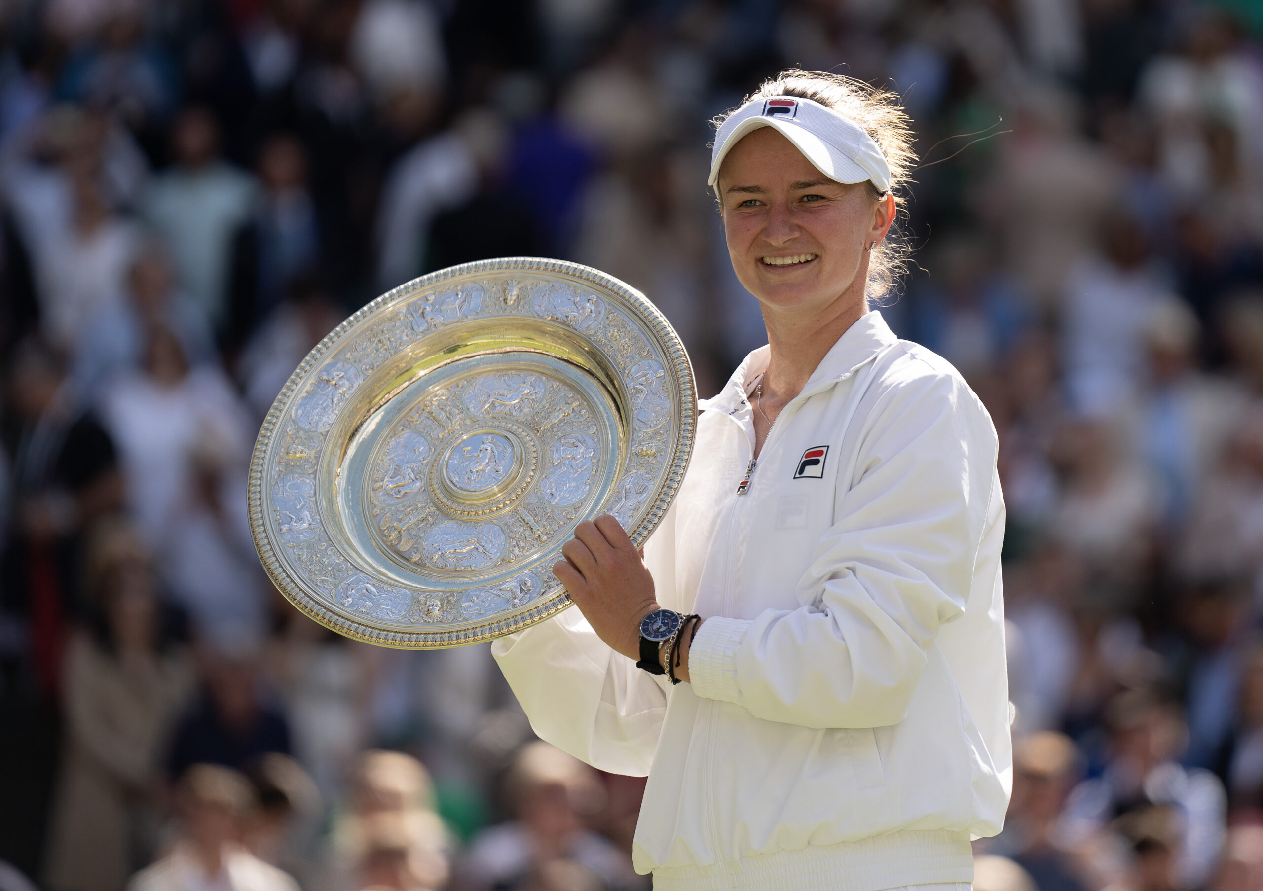 Barbora Krejcikova holds the winner's trophy after claiming the 2024 Wimbledon title