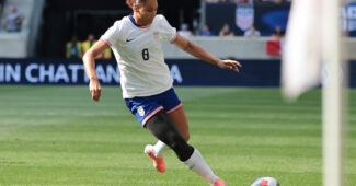 United States forward Lynn Williams, wearing a No. 8 USA jersey, kicks the ball