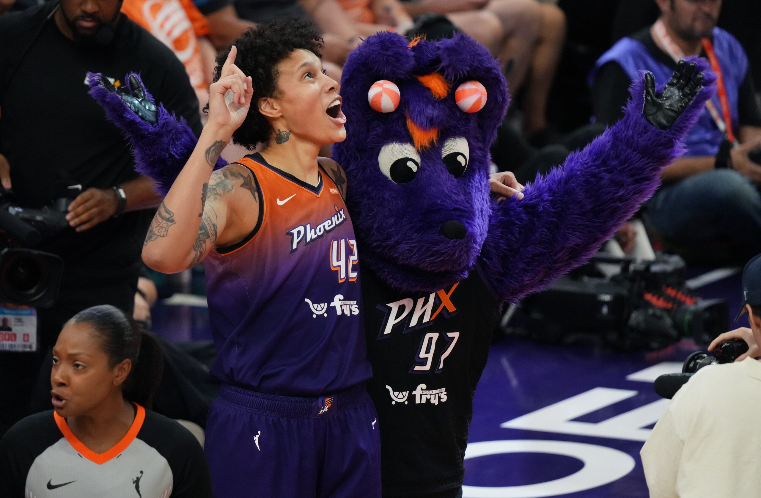 Phoenix Mercury center Brittney Griner stands alongside Mercury's furry purple mascot named Scorch