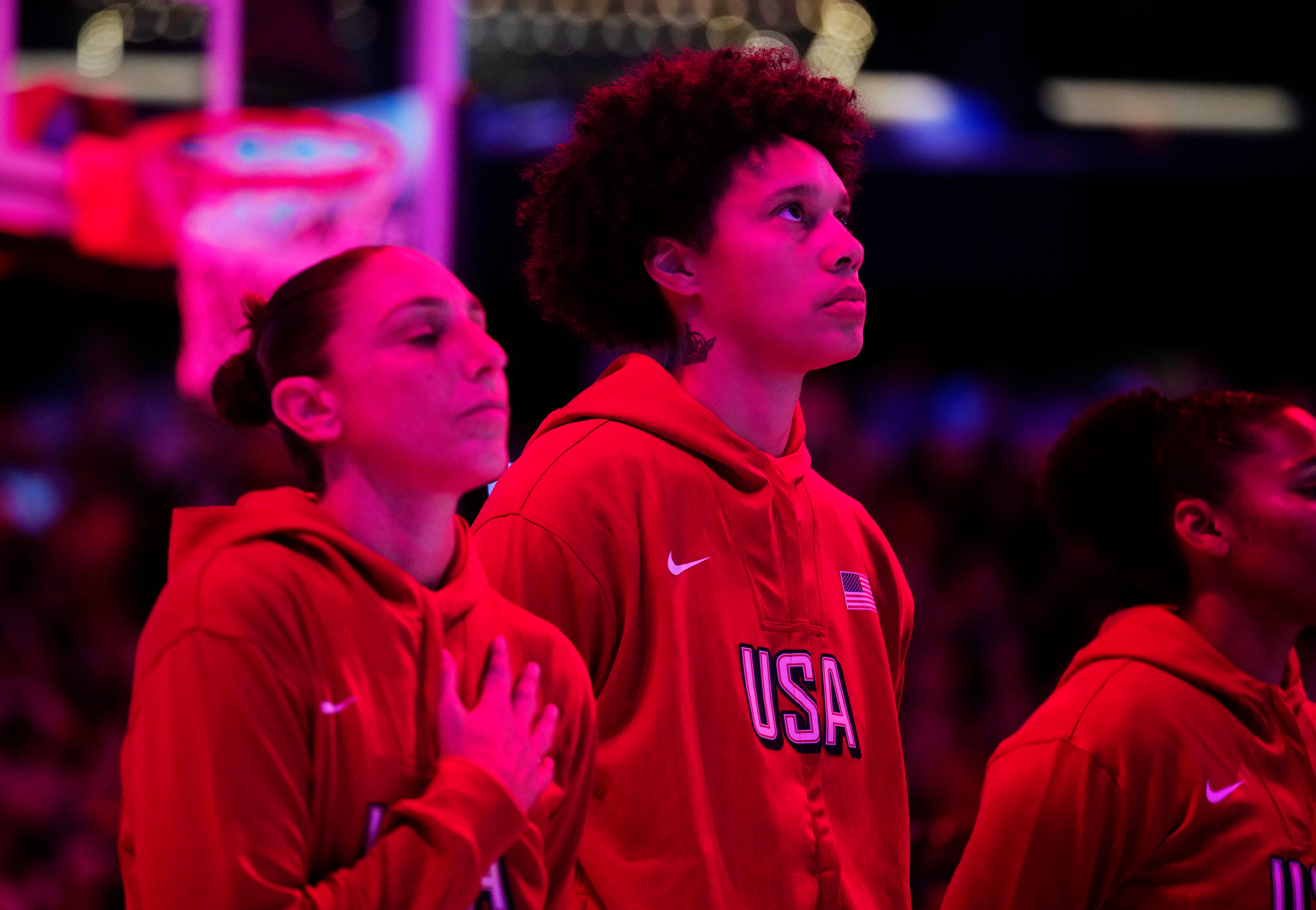 Team USA Diana Taurasi (L) with her right hand over her heart and Brittney Griner stand listening to the national anthem during the WNBA All-Star Game at Footprint Center