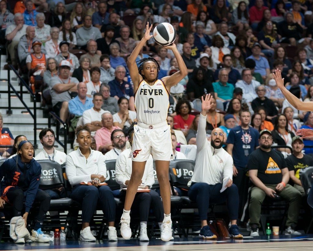 Indiana Fever guard Kelsey Mitchell shoots an open jump shot in front of the Connecticut Sun bench.