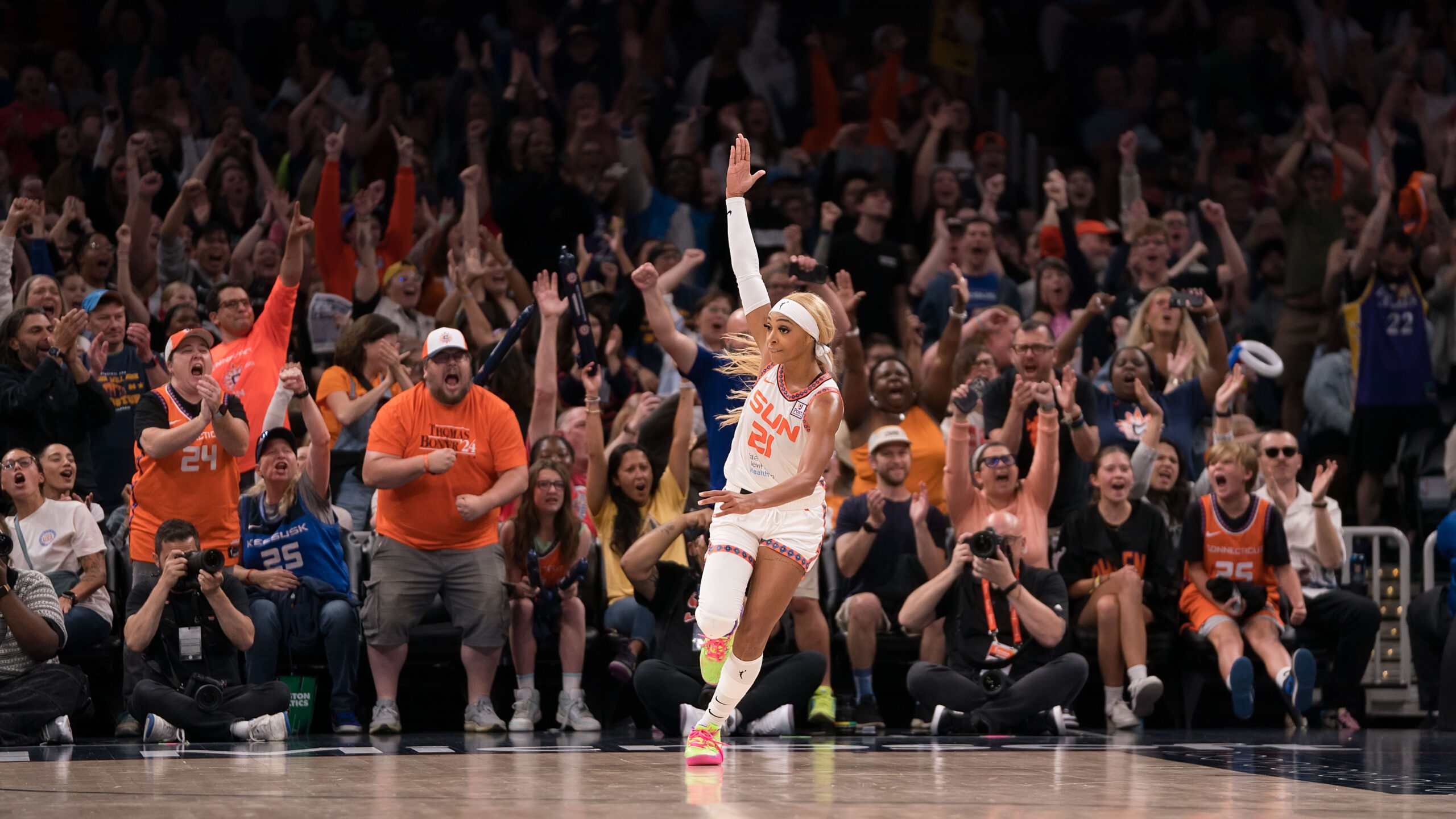Connecticut Sun guard-forward waves hand up in the air to celebrate and urge the crowd to get louder after a made layup.