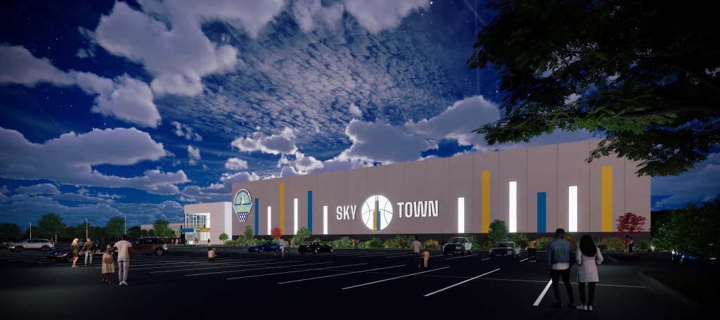 A rendering of the to-be-constructed Chicago Sky practice facility in the nighttime under the clouds.