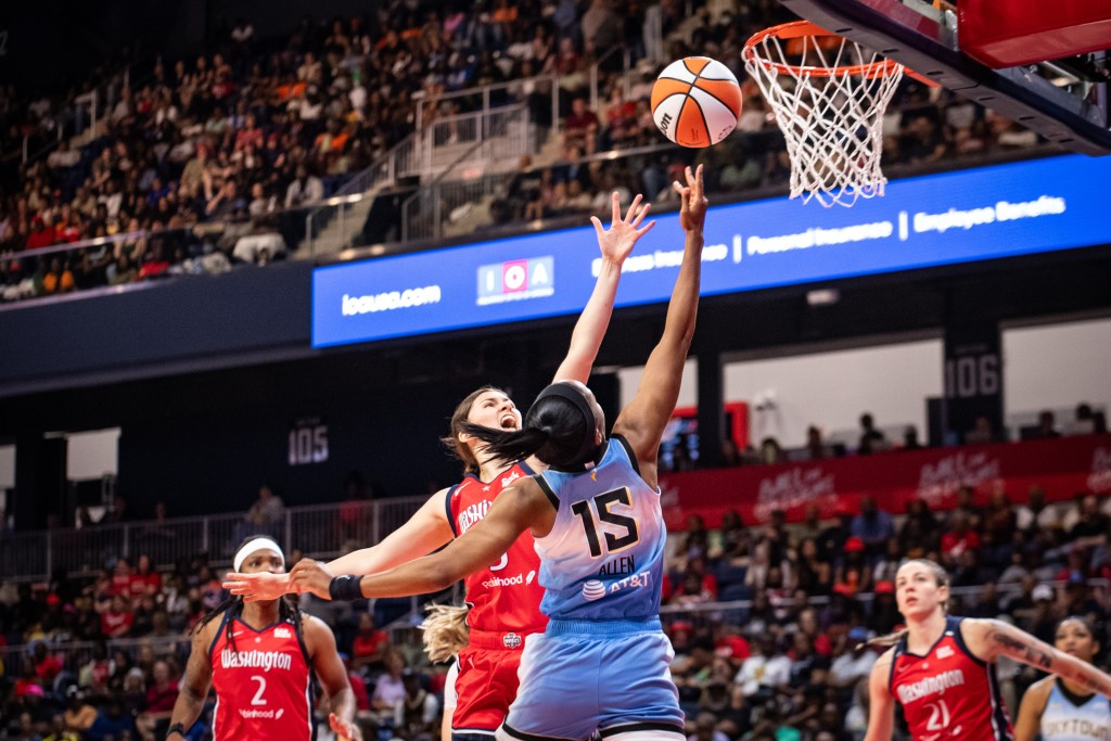 Washington Mystics guard Jade Melbourne contests a layup attempt by Chicago Sky guard Lindsay Allen. Mystics teammates Myisha Hines-Allen and Emily Engstler watch the play but are too far away to help contest.