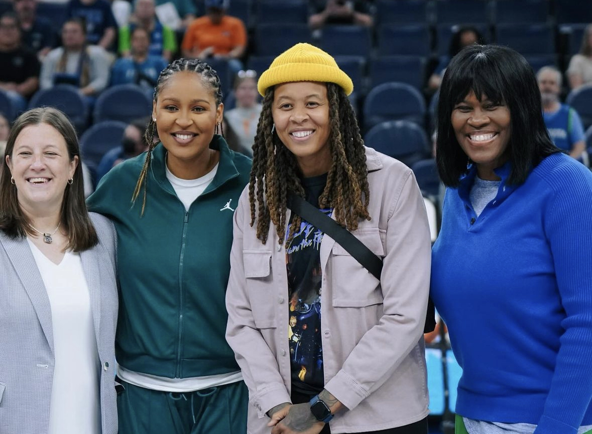 Minnesota Lynx Hall of Famers Maya Moore, Seimone Augustus and Taj McWilliams-Franklin smile for a photo with Lynx president of business operations Carley Knox.