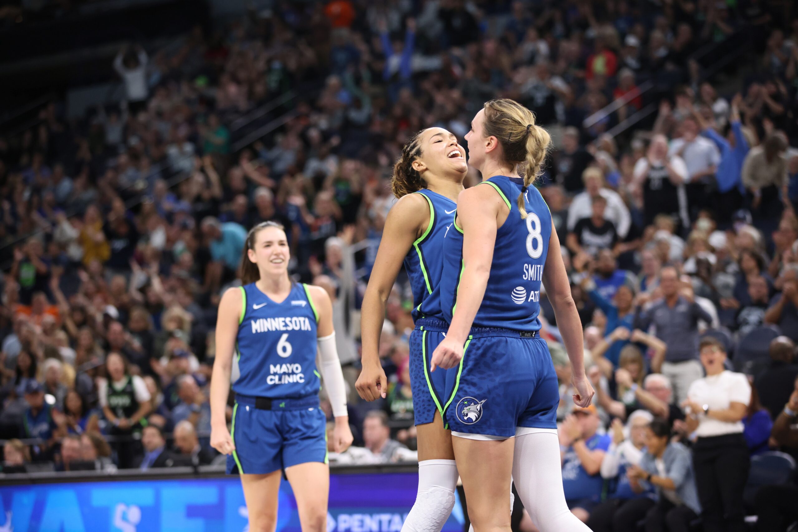 Minnesota Lynx forwards Napheesa Collier and Alanna Smith celebrate with a chest bump after Smith made a basket and drew a foul against the Washington Mystics.