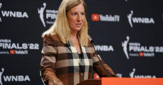 Cathy Engelbert speaks at a podium.