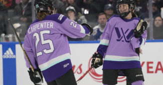 PWHL players motion towards eachother during the NHL 3x3 showcase