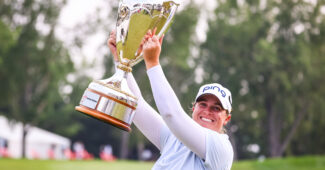 Lauren Coughlin celebrates with the winner's trophy during the final round of the CPKC Women's Open golf tournament.