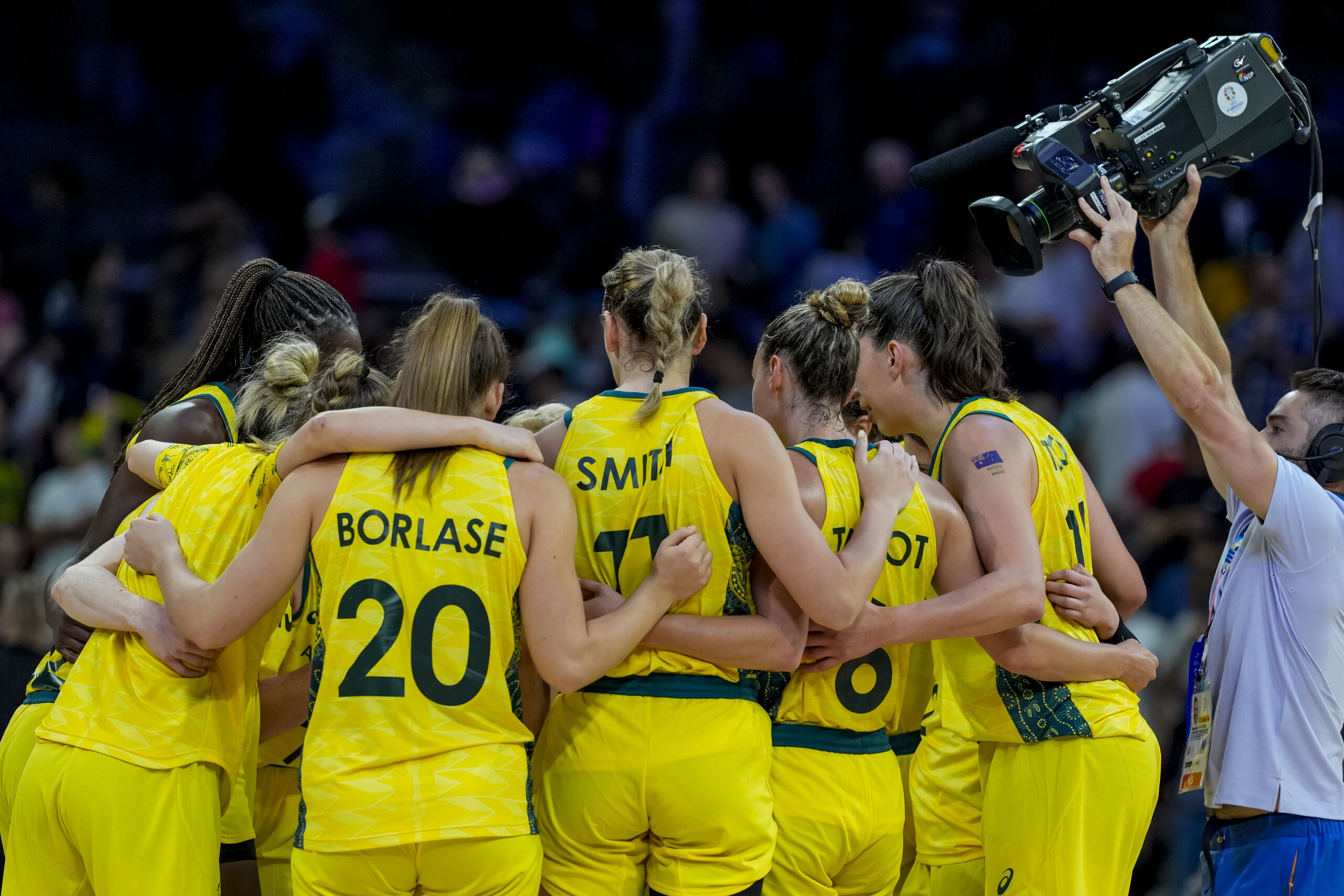 The Australia women’s basketball team huddles on the court