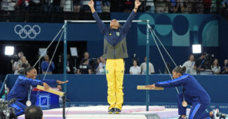American gymnasts Simone Biles and Jordan Chiles bow to Brazil's Rebeca Andrade on the podium after the Olympic floor exercise final.