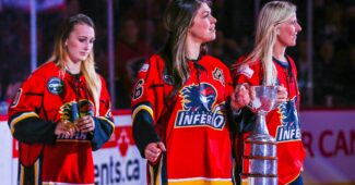 Three players wearing red Calgary Flames hockey jerseys