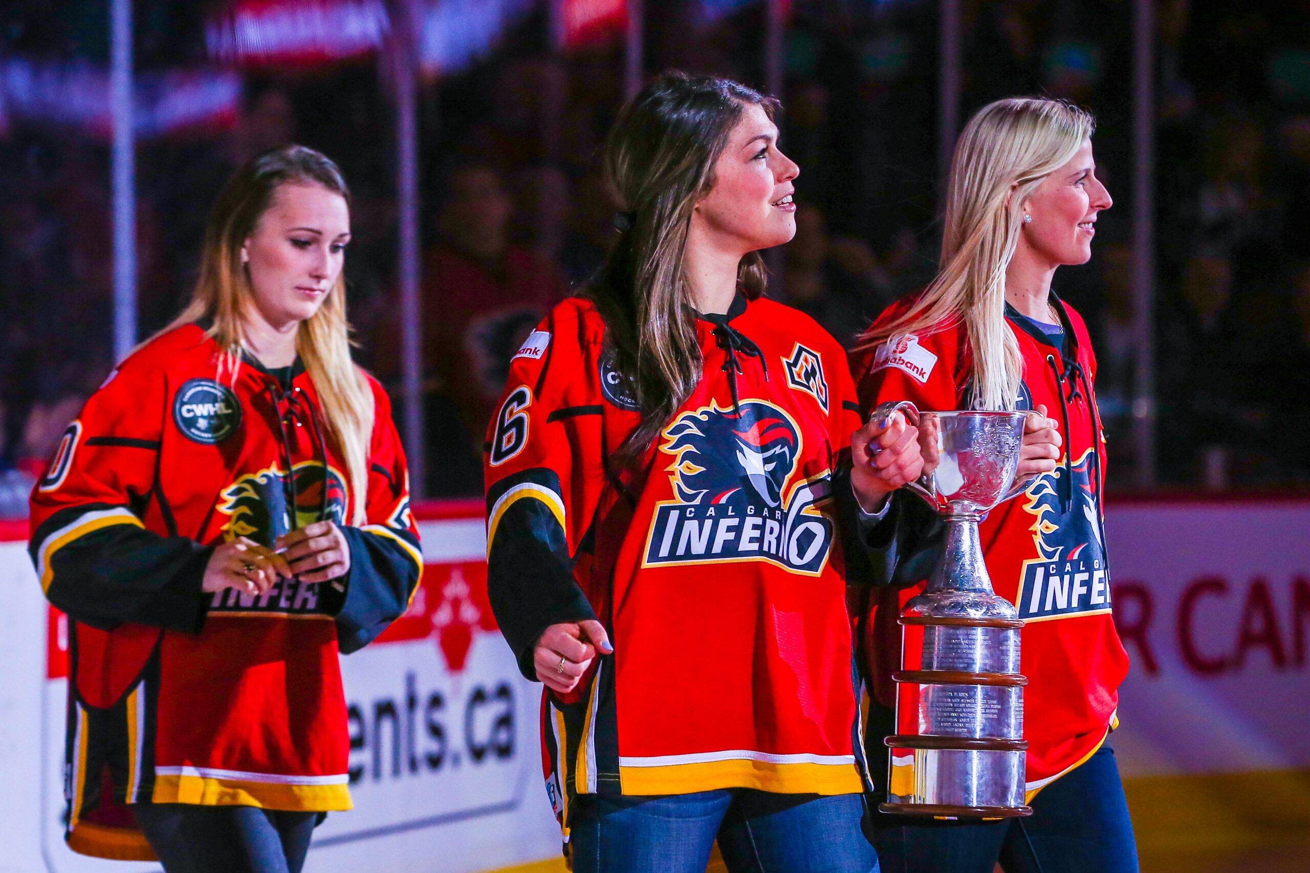 Three players wearing red Calgary Flames hockey jerseys