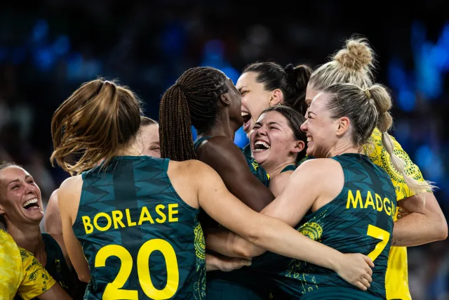 Members of the Australian women's basketball national team celebrate a silver medal