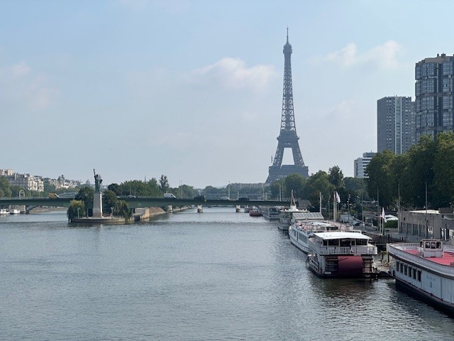 A river in Paris is pictured with the Eiffel Tower pictured in the backdrop