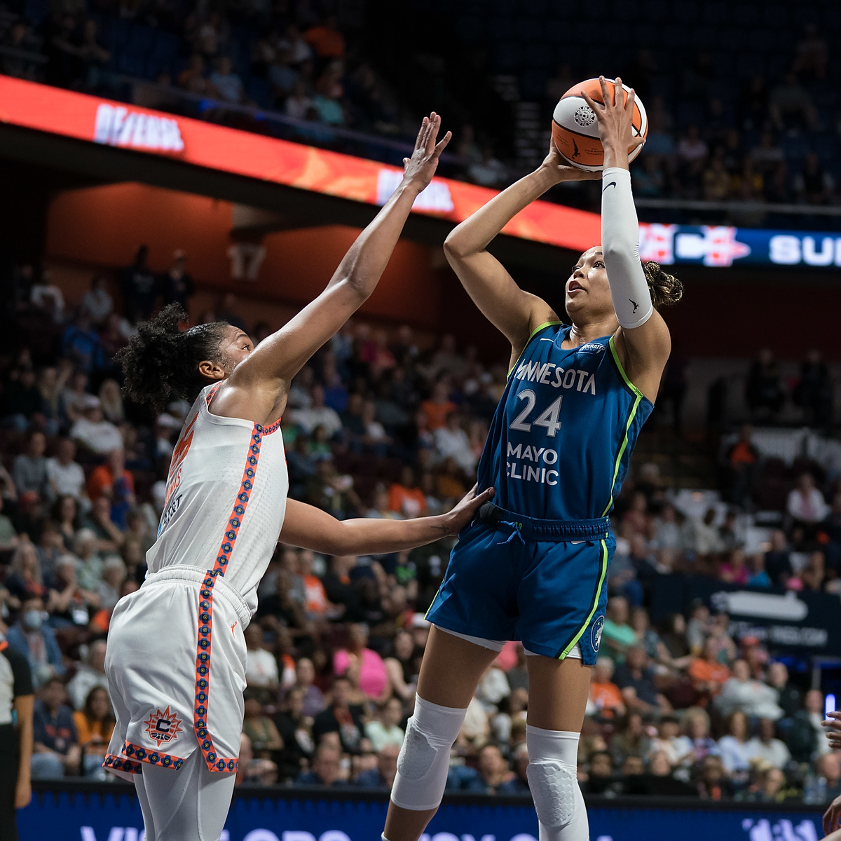 Connecticut Sun forward Alyssa Thomas puts her hand up to block Napheesa Collier's shot.