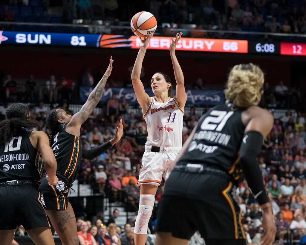 Phoenix Mercury wing Rebecca Allen (11) shoots the ball over a defender's outstretched arm