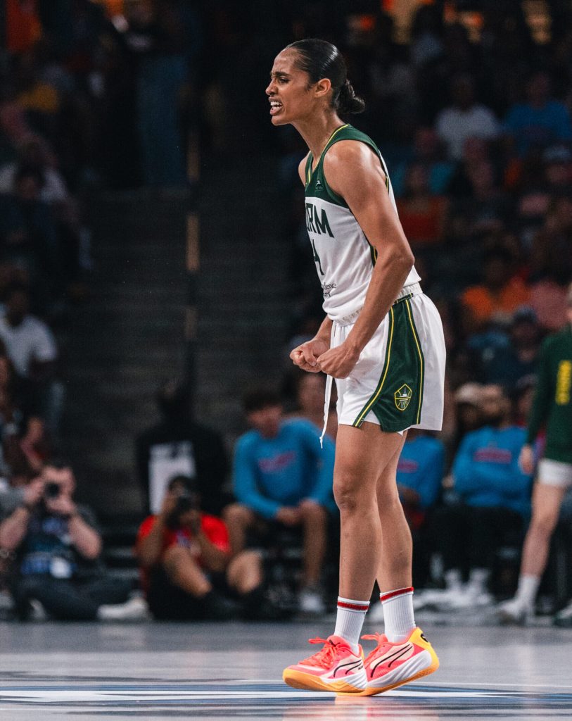 Seattle Storm guard Skylar Diggins-Smith clenches her fists and scrunches her face in celebration during a game.