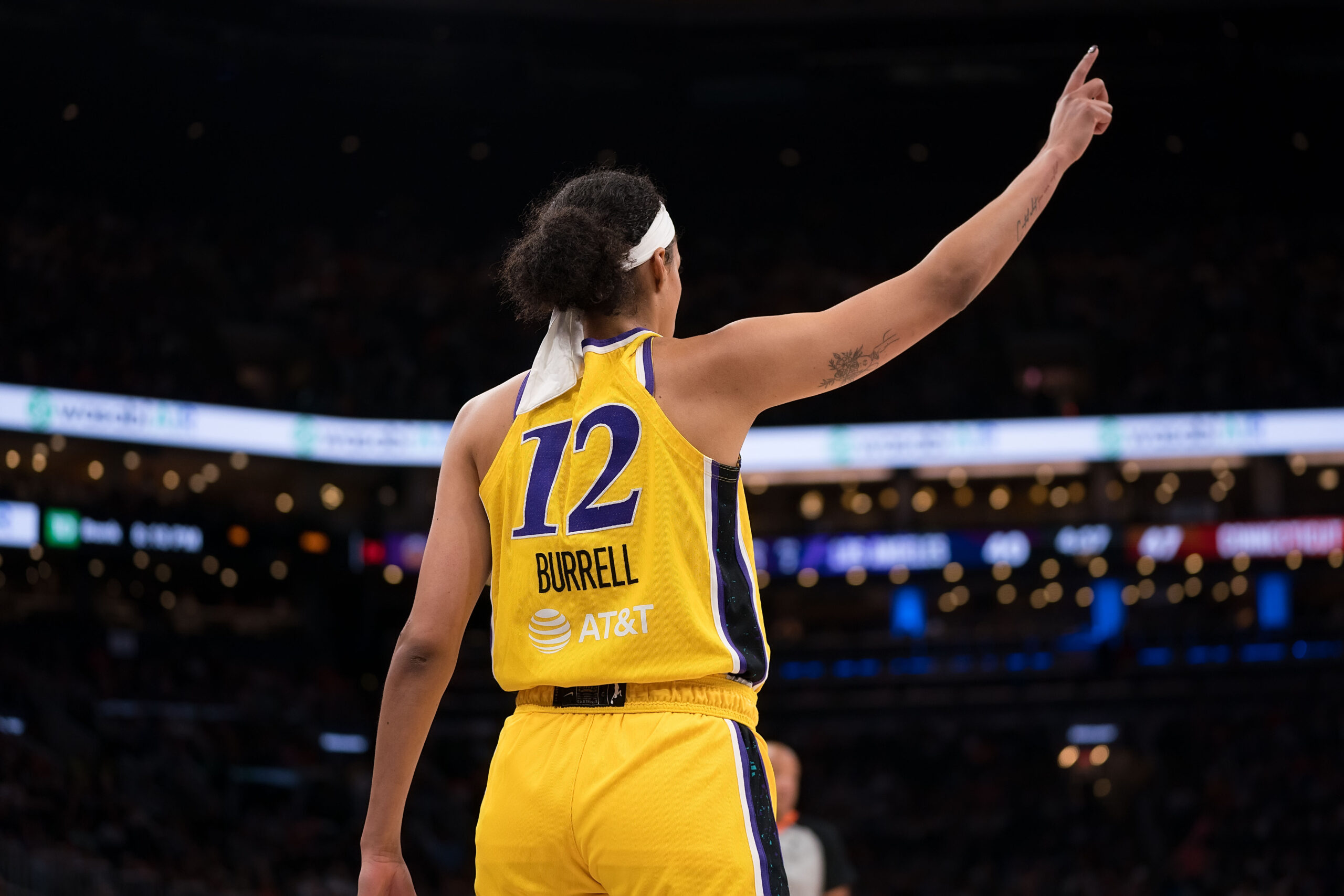 Los Angeles Sparks guard Rae Burrell points upwards in a game against the Connecticut Sun.