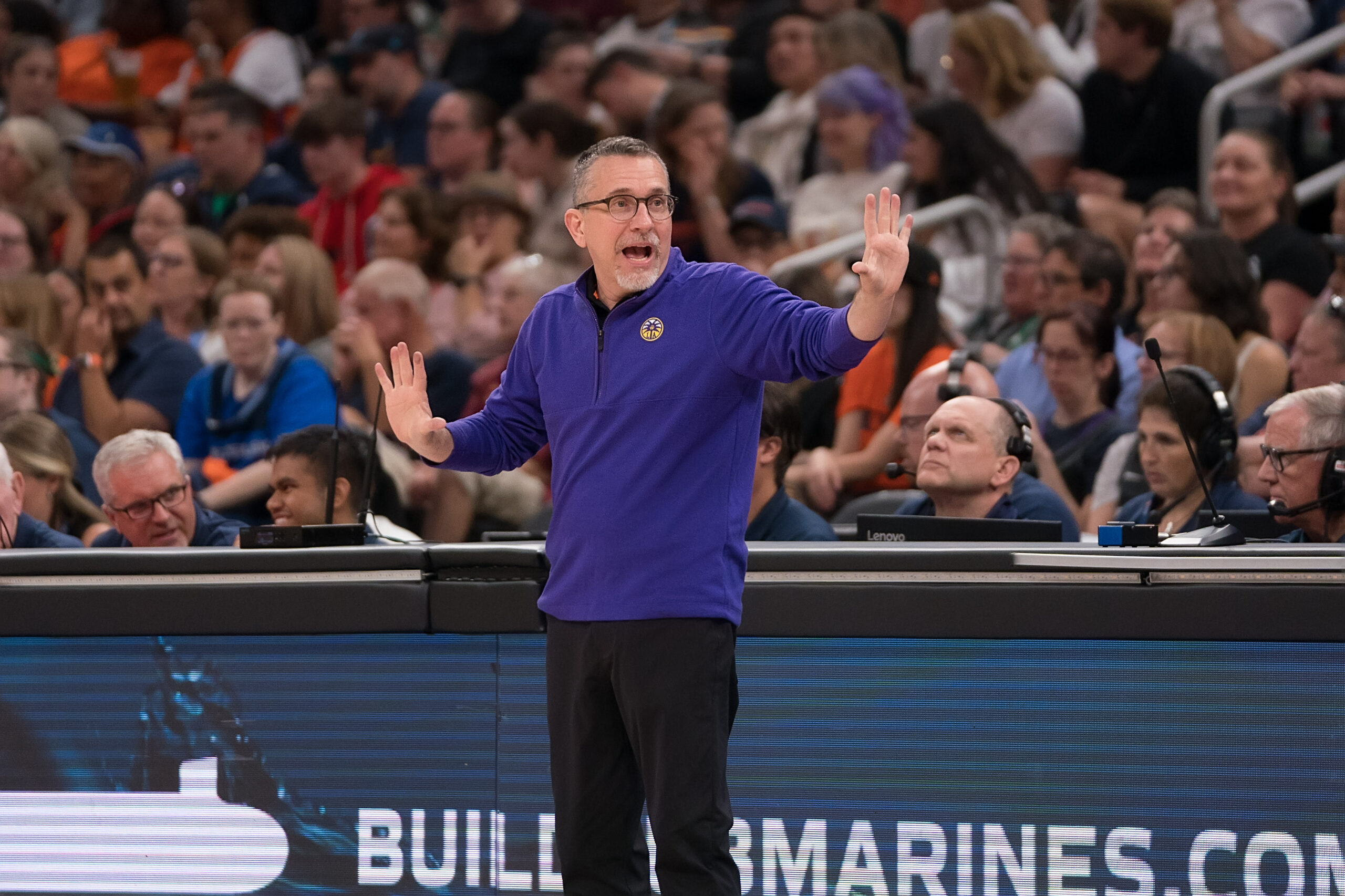 Los Angeles Sparks Coach Curt Miller holds up both hands in a game between the Connecticut Sun and the Los Angeles Sparks.
