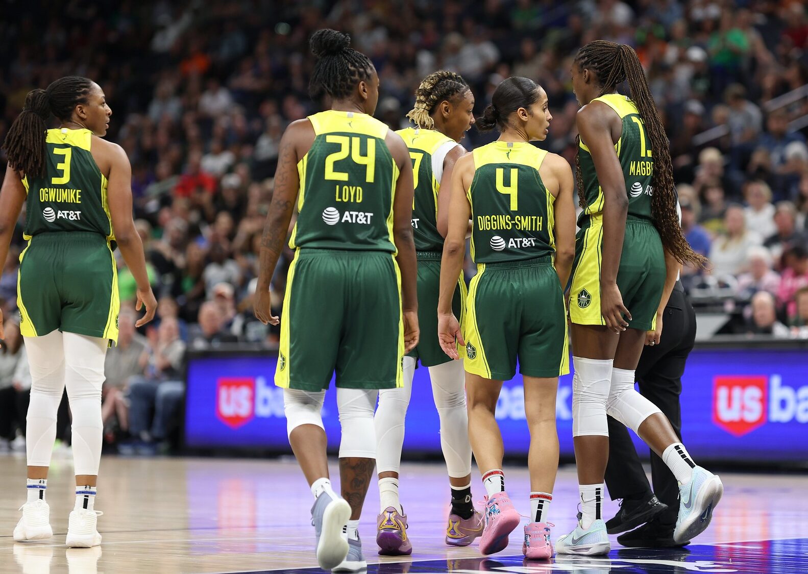 Seattle Storm guard Skylar Diggins-Smith and several teammates walk off the court. Their backs are to the camera.
