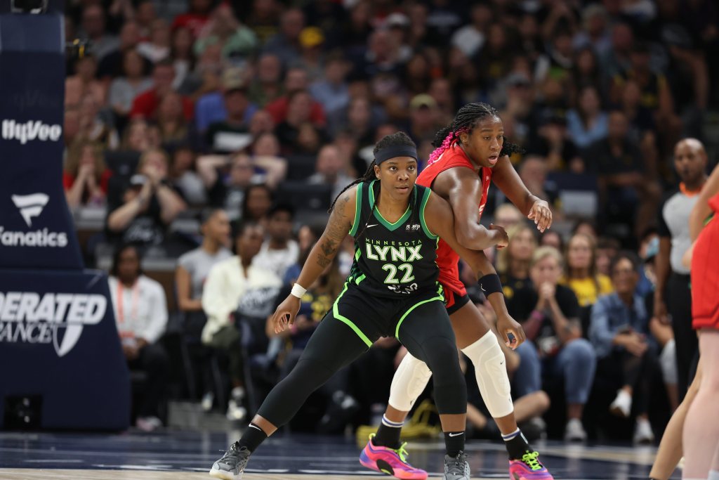 Minnesota Lynx forward Myisha Hines-Allen bends her knees and pushes back against Indiana Fever forward/center Aliyah Boston as Boston attempts to get around her.