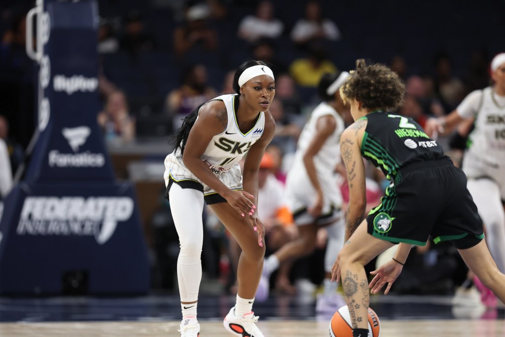 Chicago Sky guard Dana Evans gets into a defensive stance to guard Minnesota Lynx guard Natisha Hiedeman.