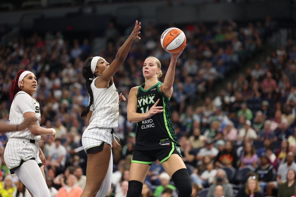 Chicago Sky forward Angel Reese gets a hand up against Minnesota Lynx forward Dorka Juhasz