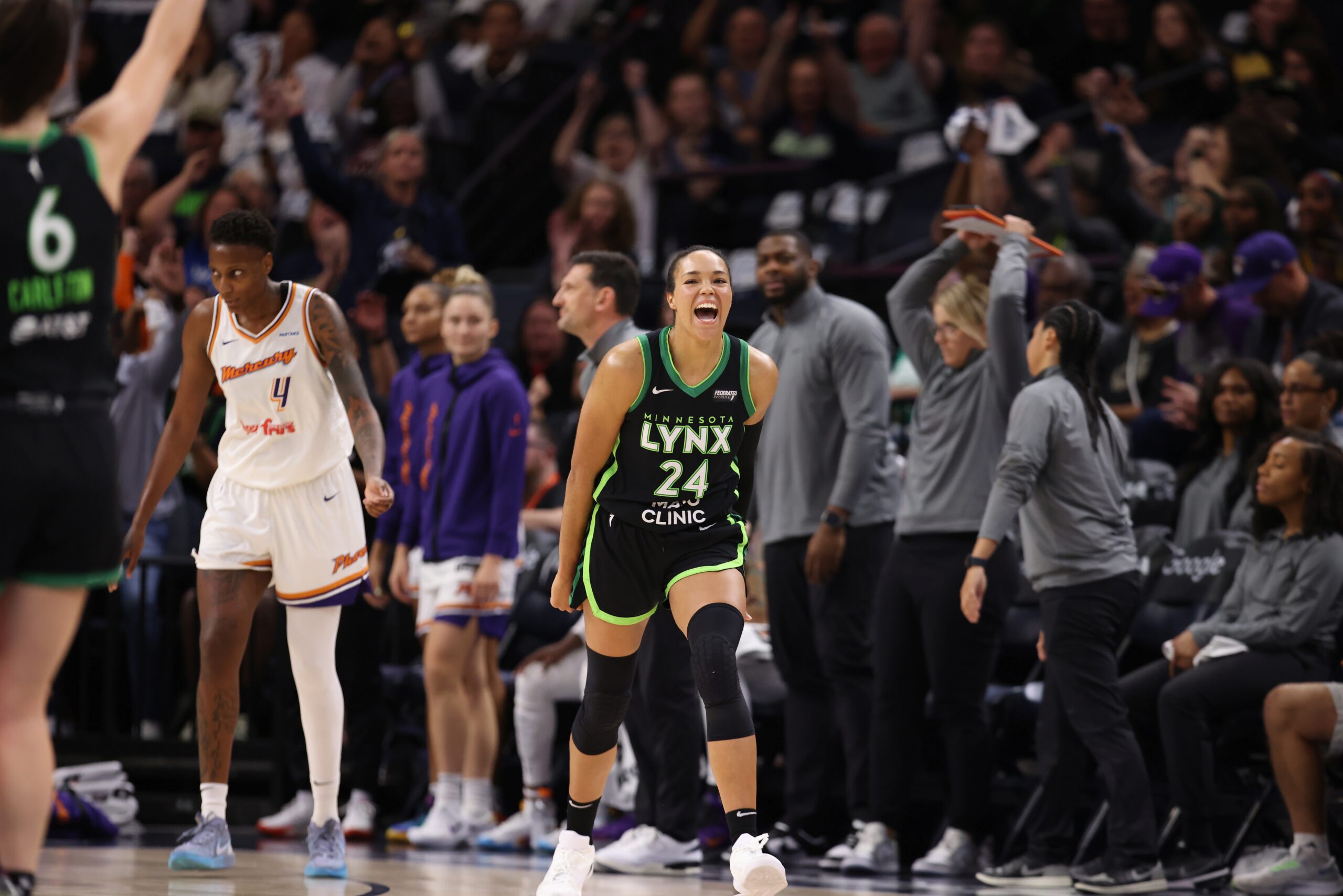 Napheesa Collier (24) runs down the cout in front of the Phoenix Mercury's bench during the WNBA Playoffs