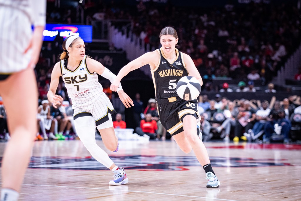 Washington Mystics point guard Jade Melbourne dribbles the ball on the perimeter with her left hand as Chicago Sky guard Chennedy Carter tries to stay on her hip.