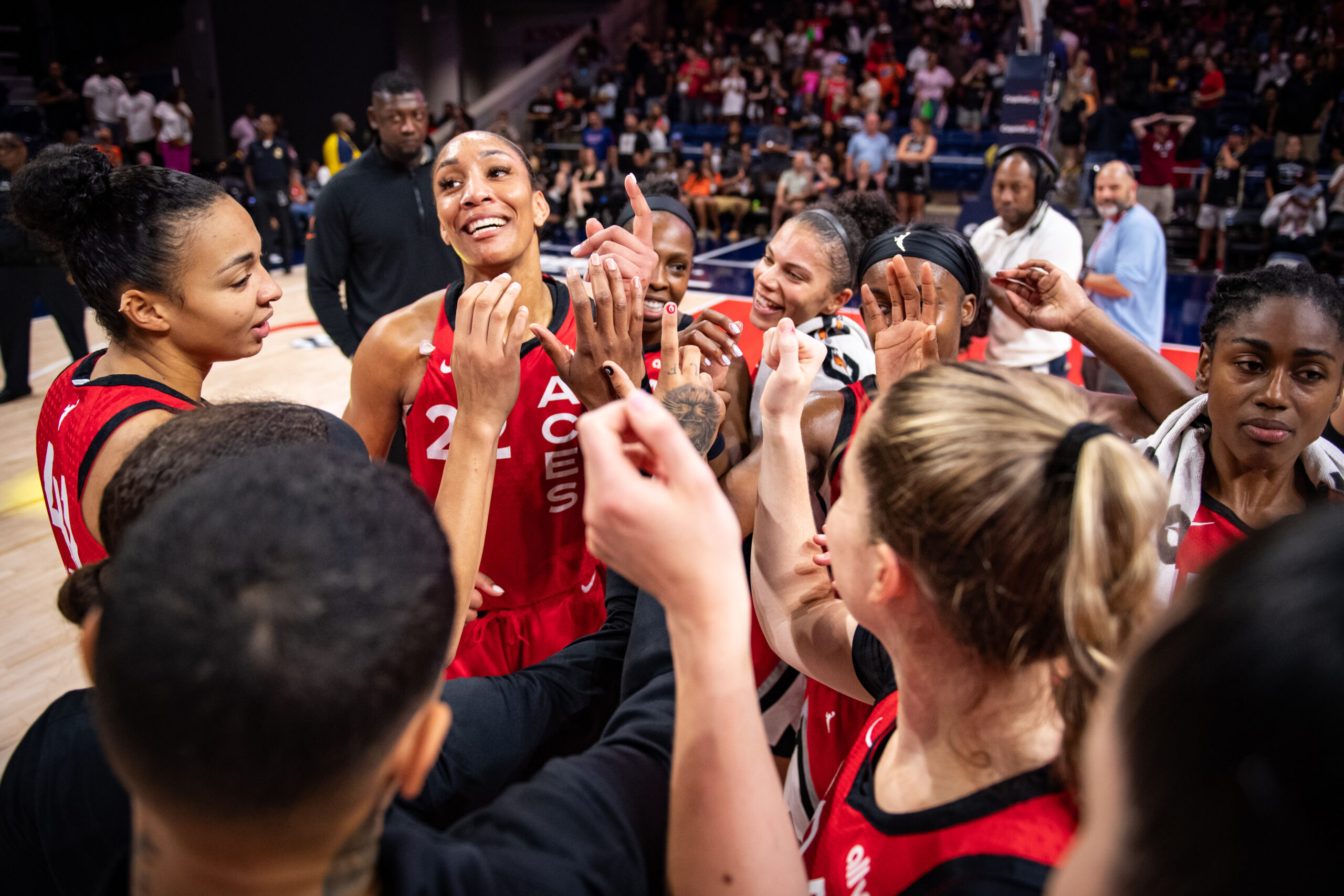 The Las Vegas Aces huddle together to celebrate a win over the Washington Mystics.