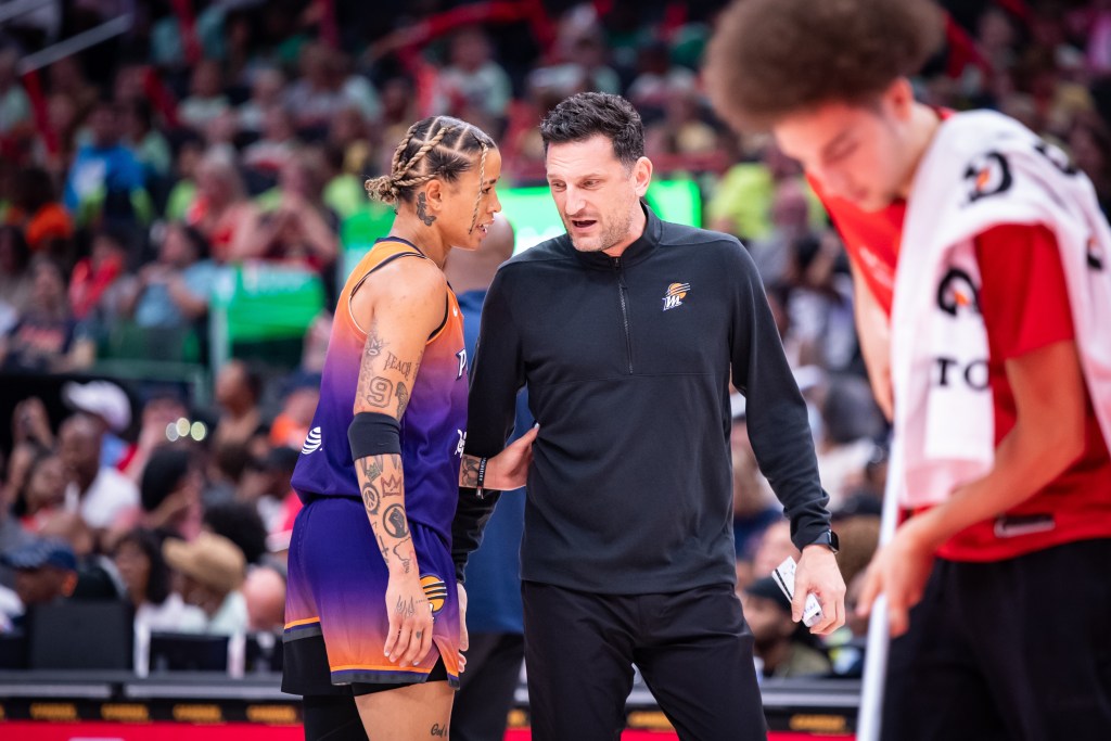 Phoenix Mercury guard Natasha Cloud (0)talks to  head coach Nate Tibbetts with her hand on his back