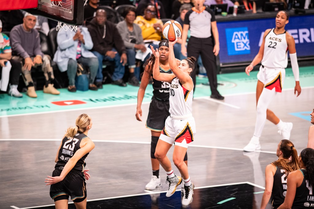 Las Vegas Aces guard Kelsey Plum shoots a left-handed floater in the paint. No New York Liberty defender is close enough to contest the shot.
