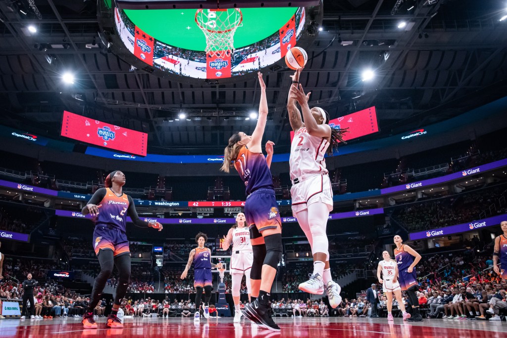 Washington Mystics forward Myisha Hines-Allen attempts a close-range shot with her right hand as Phoenix Mercury forward/guard Rebecca Allen tries to contest it.
