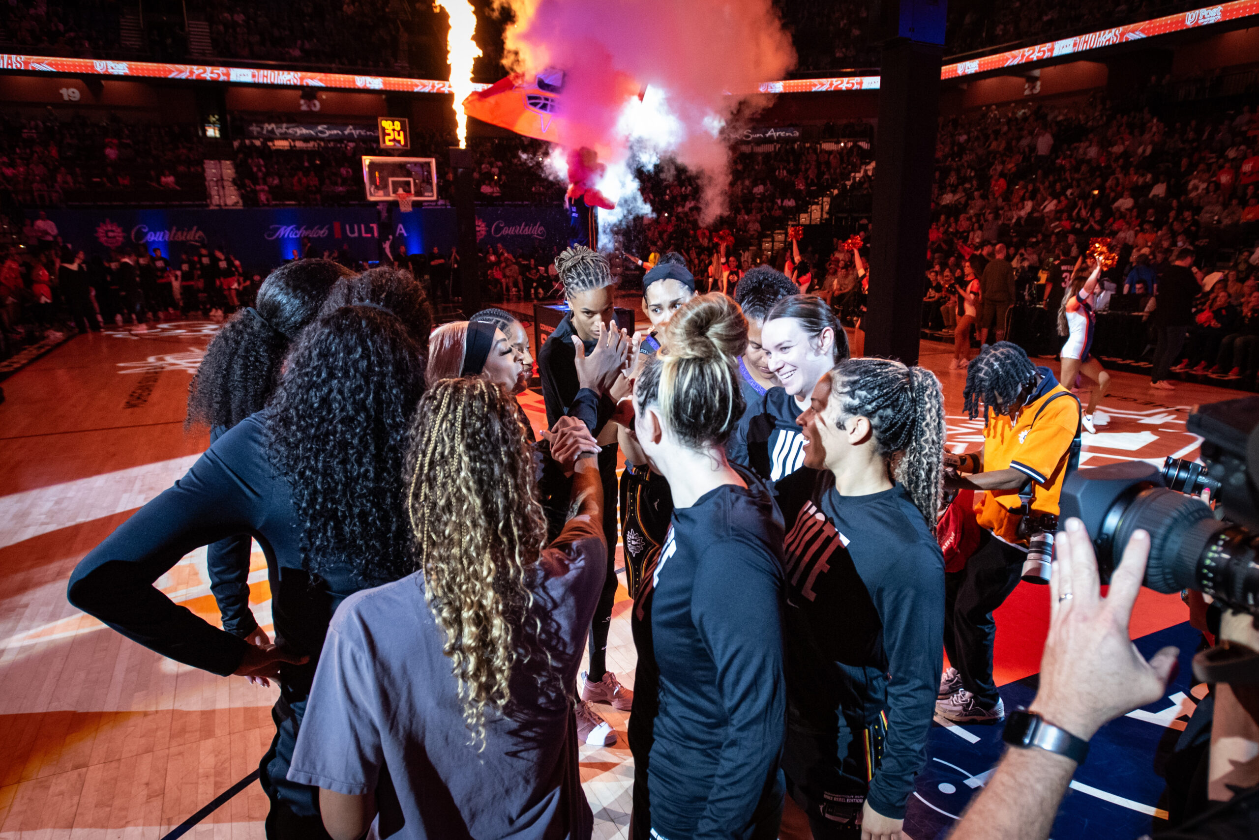 Connecticut Sun players gather in a circle before a game against the Las Vegas Aces.