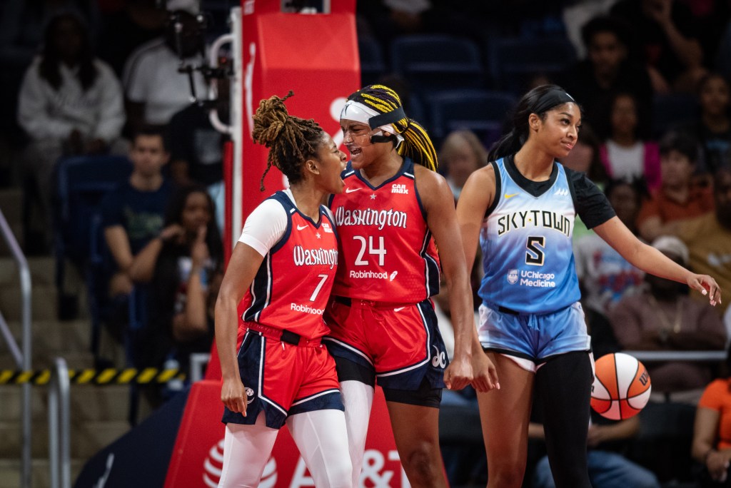 Washington Mystics guard Ariel Atkins and forward Aaliyah Edwards come together and yell as they celebrate a play.