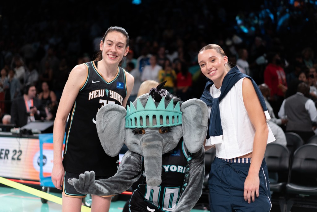Breanna Stewart, Ellie the Elephant and Paige Bueckers smile together for a photo