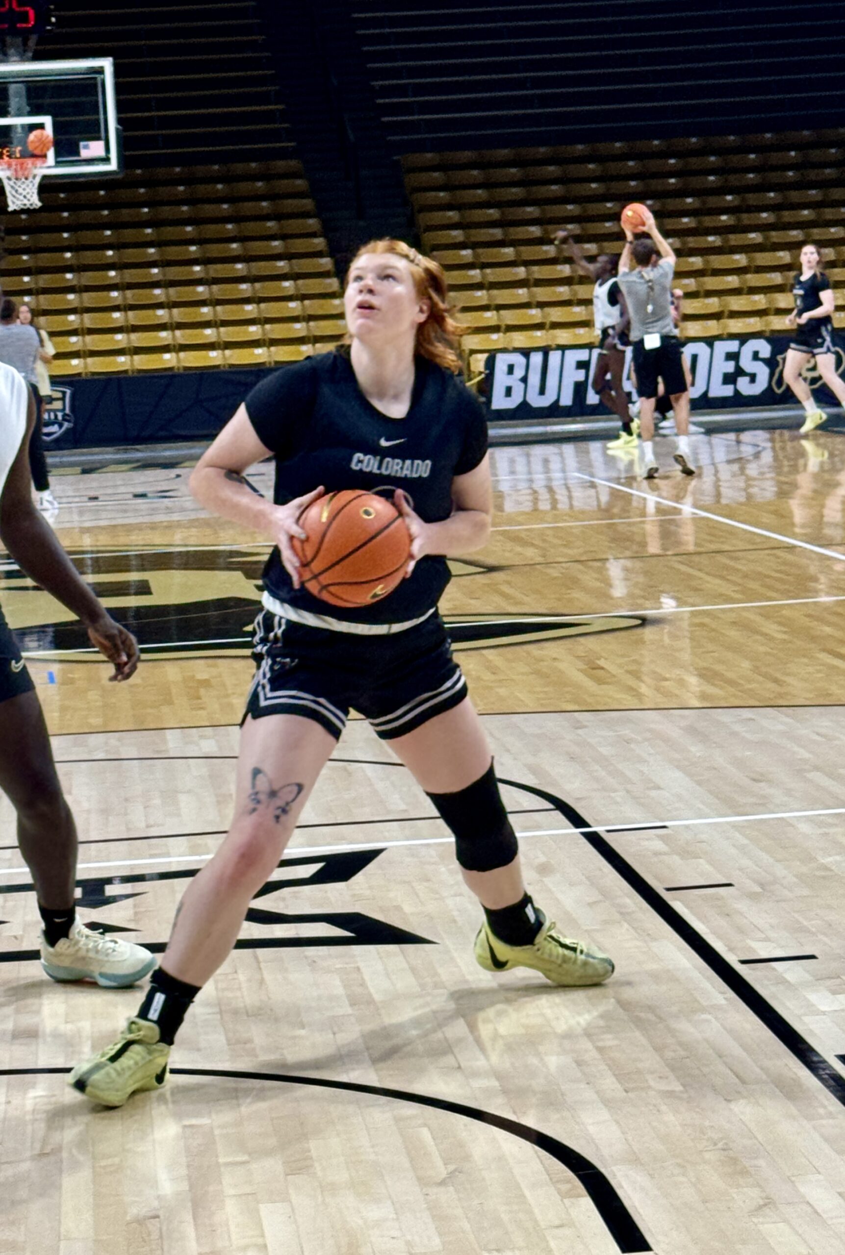 Freshman post player Tabitha Benton looks at the basket as she prepares to shoot a close-range shot in practice.