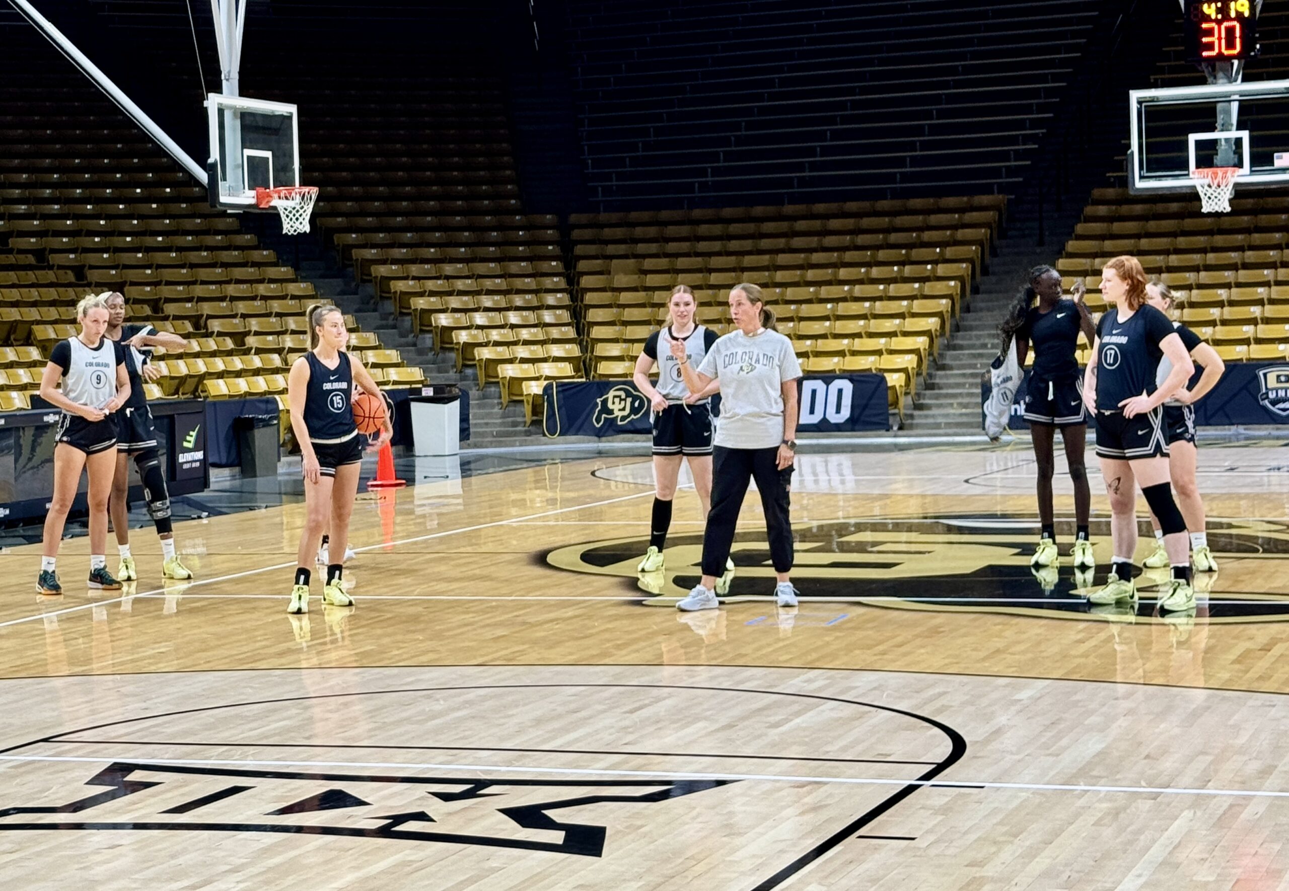 Colorado head coach JR Payne gestures toward her players during practice as she explains a drill.