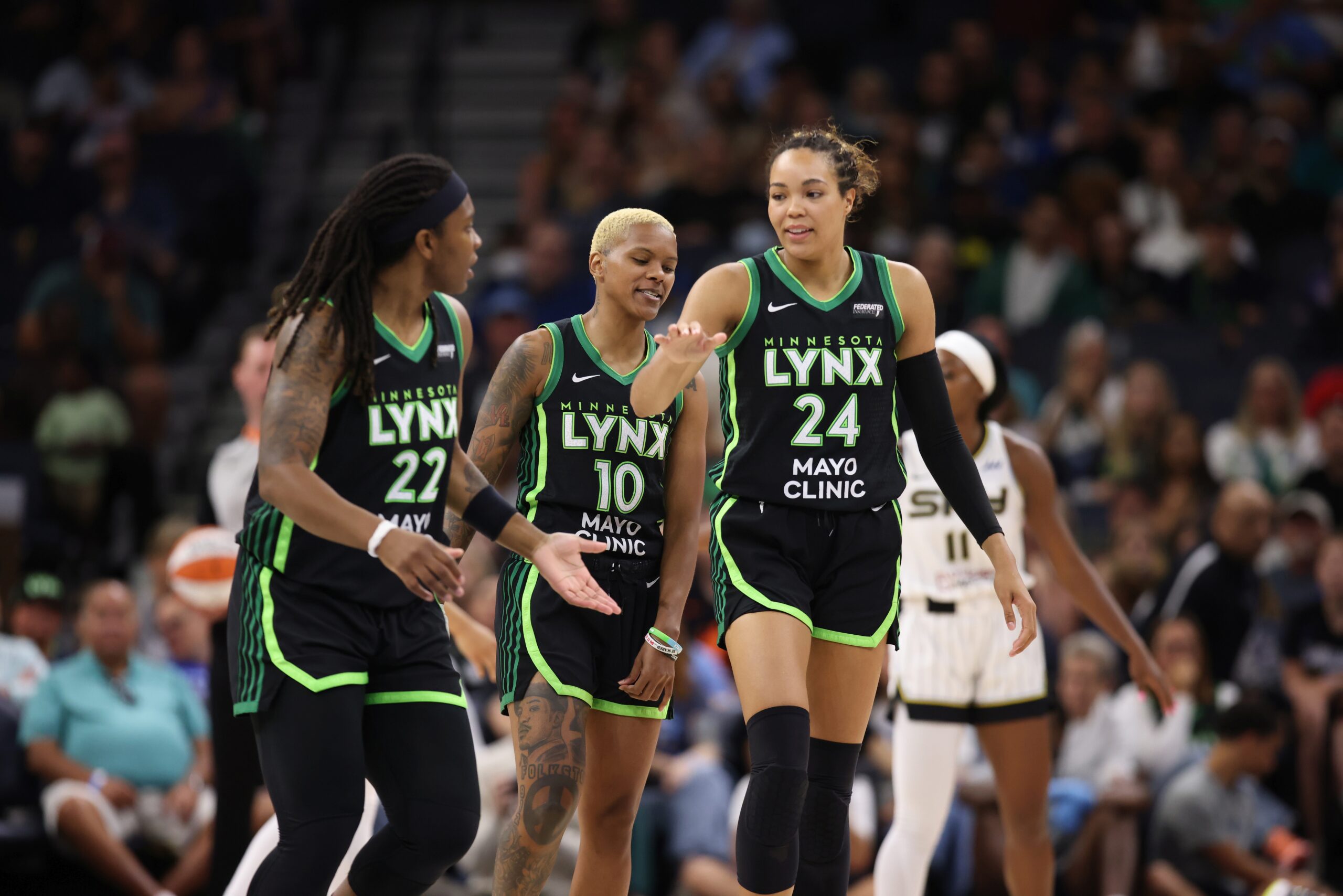Napheesa Collier, congratulates Myisha Hines-Allen after a play against the Chicago Sky