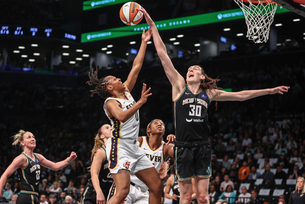 Breanna Stewart blocks a shot attempt from Indiana Fever guard Kelsey Mitchell.