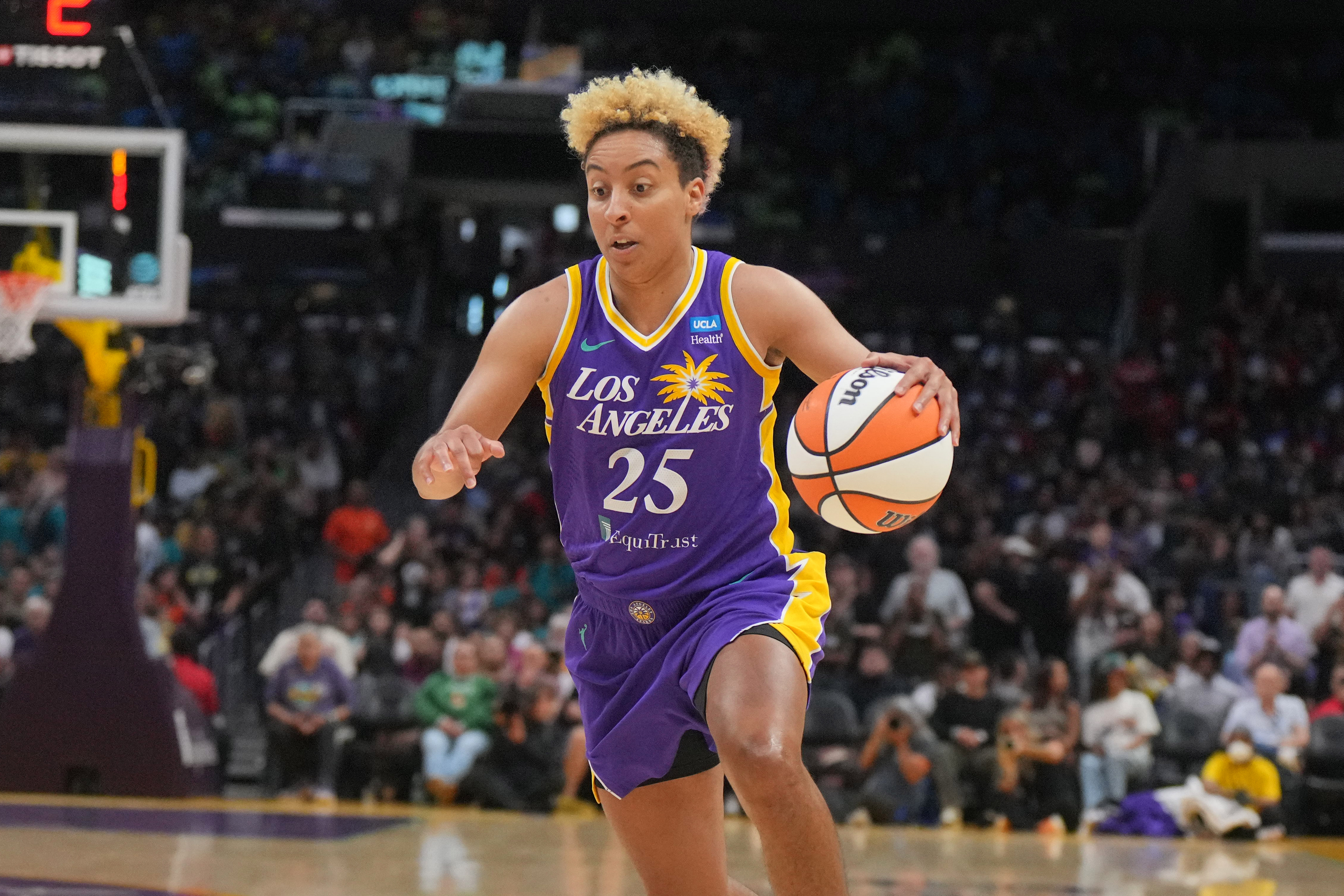 Los Angeles Sparks guard Layshia Clarendon dribbles the ball for the Sparks in a game against the Seattle Storm.