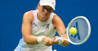 Iga Swiatek hits a backhand in her U.S. Open fourth round match