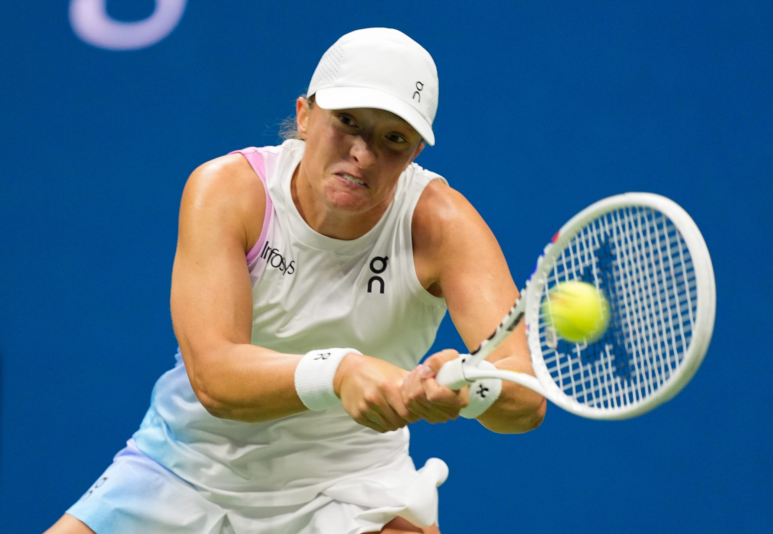 Iga Swiatek hits a backhand in her U.S. Open fourth round match