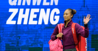 Zheng Qinwen waves to the crowd as she entered the court at the 2024 U.S. Open.