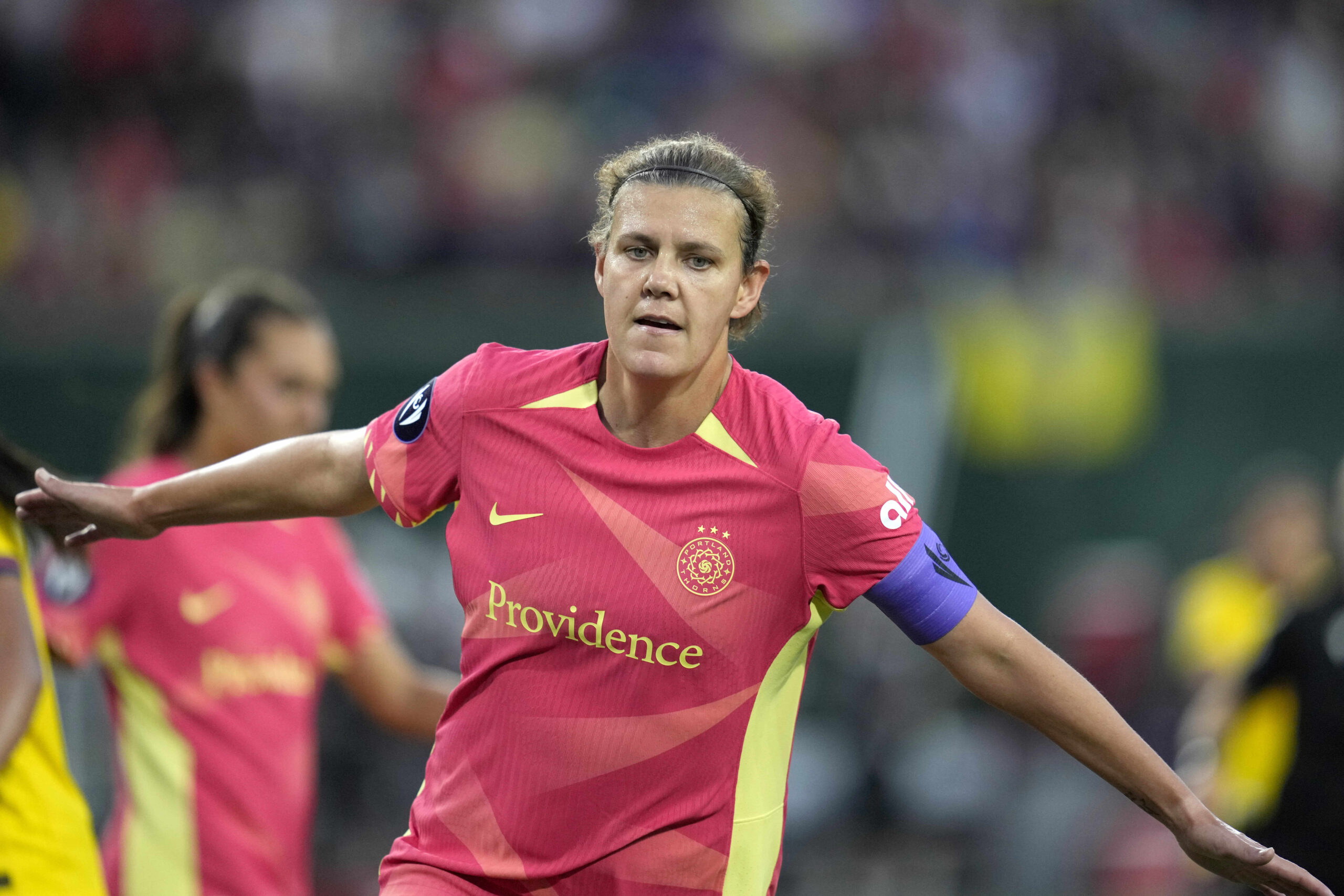 Christine Sinclair celebrates a goal with outstretched arms